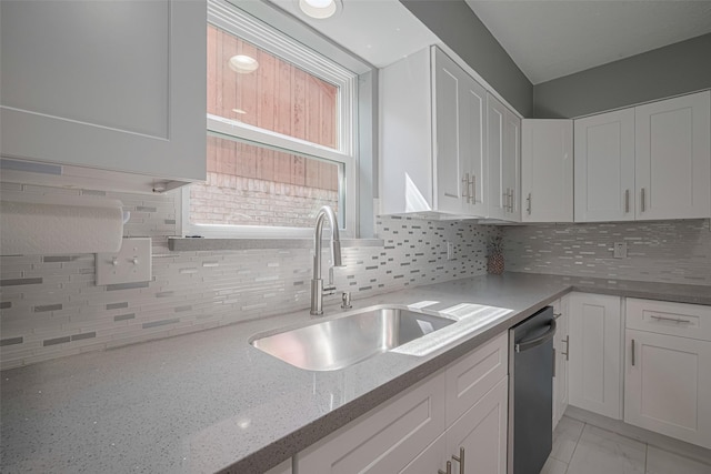 12206 Green Glade Dr, Houston, TX 77099 - kitchen featuring stainless steel dishwasher, white cabinets, and tasteful backsplash