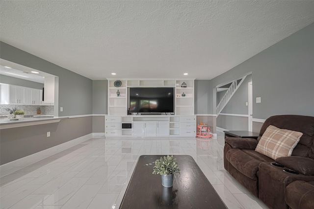 12206 Green Glade Dr, Houston, TX 77099 - living area featuring a textured ceiling, light marble finish flooring, and recessed lighting