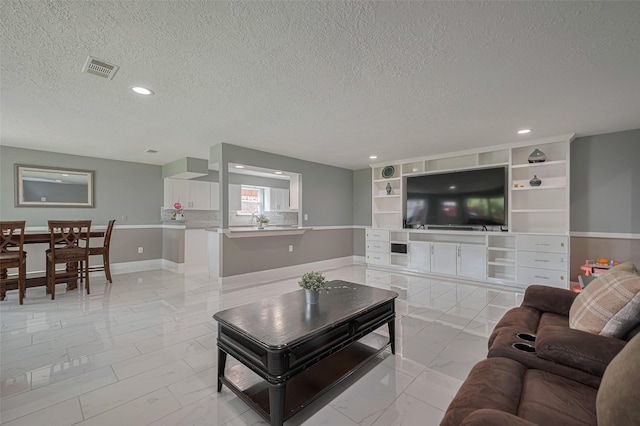 12206 Green Glade Dr, Houston, TX 77099 - living room featuring light marble finish flooring, a textured ceiling, and recessed lighting