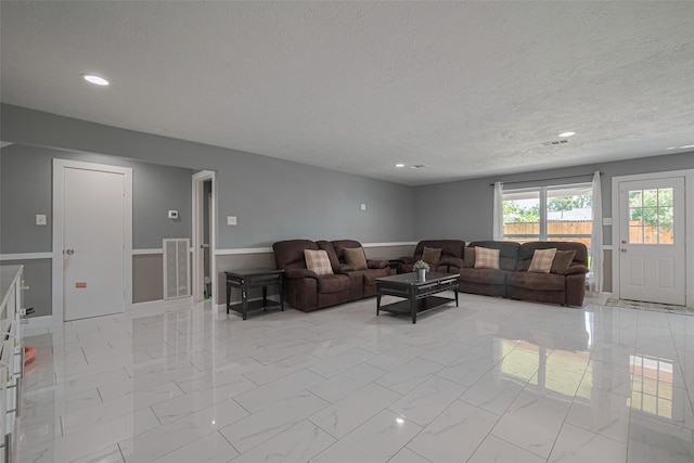 12206 Green Glade Dr, Houston, TX 77099 - living area with a textured ceiling, light marble finish floors, and recessed lighting