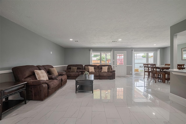12206 Green Glade Dr, Houston, TX 77099 - living room with a textured ceiling, plenty of natural light, and recessed lighting