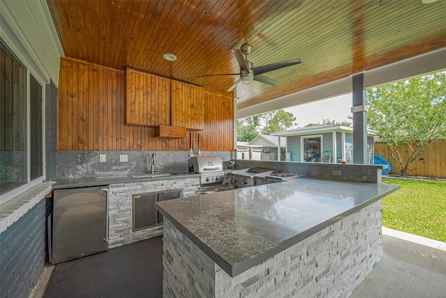 12206 Green Glade Dr, Houston, TX 77099 - view of patio with exterior kitchen, an outdoor structure, and ceiling fan