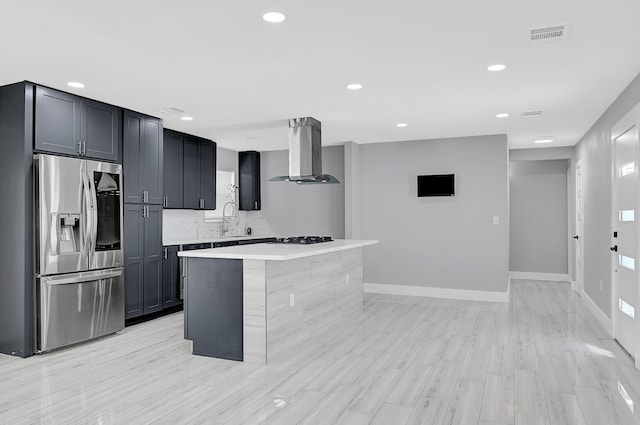 4927 Kelso St, Houston, TX 77021 - kitchen with stainless steel fridge with ice dispenser, wall chimney range hood, light countertops, decorative backsplash, and recessed lighting