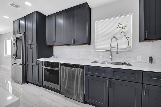 4927 Kelso St, Houston, TX 77021 - kitchen with appliances with stainless steel finishes, backsplash, and recessed lighting