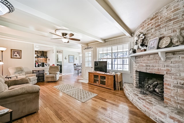114 Wyndwood Dr, Seabrook, TX 77586 - living room featuring light wood-style floors, beamed ceiling, ceiling fan, and a fireplace