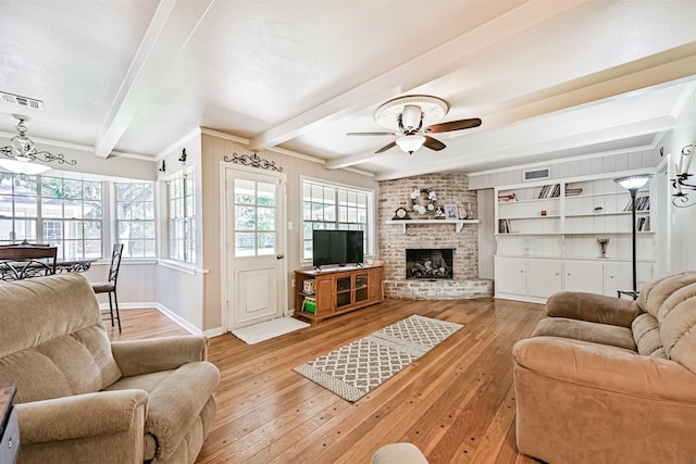 114 Wyndwood Dr, Seabrook, TX 77586 - living area with beamed ceiling, ceiling fan, light wood finished floors, and a fireplace