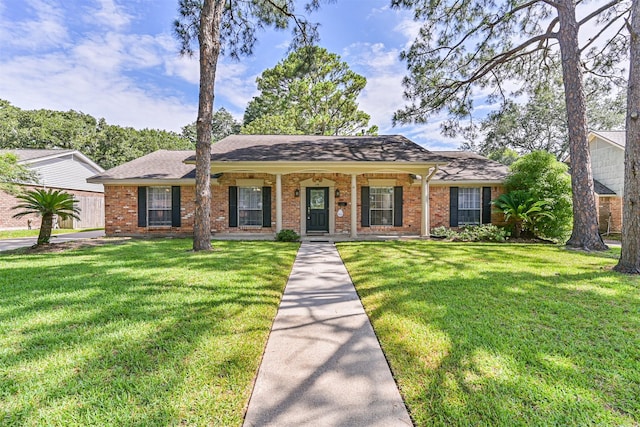 114 Wyndwood Dr, Seabrook, TX 77586 - ranch-style house featuring a front lawn, brick siding, roof with shingles, and covered porch