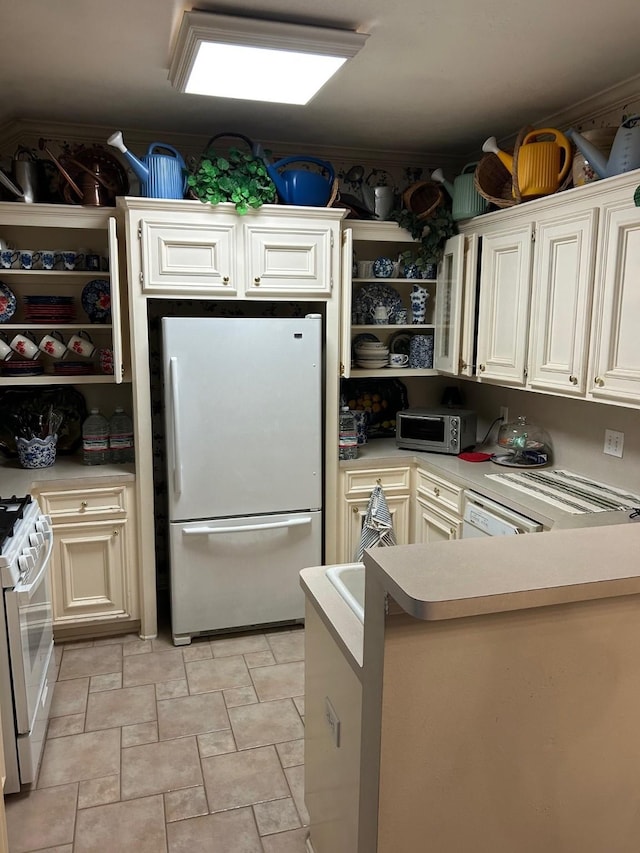 1110 Ivy Ave, Deer Park, TX 77536 - kitchen with freestanding refrigerator, gas range gas stove, open shelves, stainless steel microwave, and light countertops