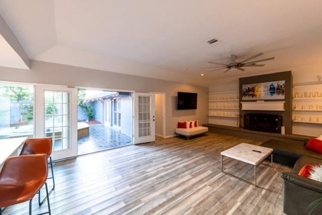 230 White Cedar St, Houston, TX 77015 - living room with a fireplace, wood finished floors, and ceiling fan