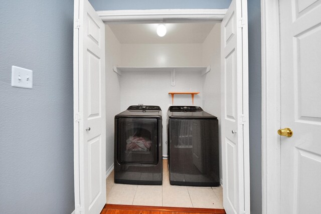 14907 Leila Oaks Cir, Houston, TX 77082 - washroom with washing machine and dryer and tile patterned floors
