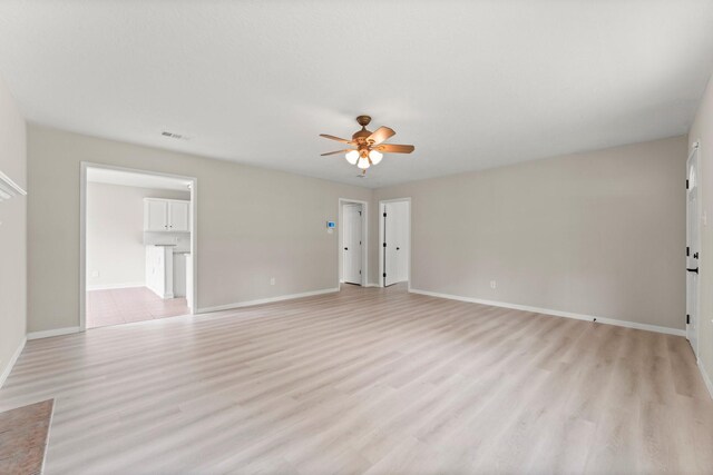 519 Tallow Dr, Conroe, TX 77385 - unfurnished living room featuring ceiling fan and light wood-type flooring