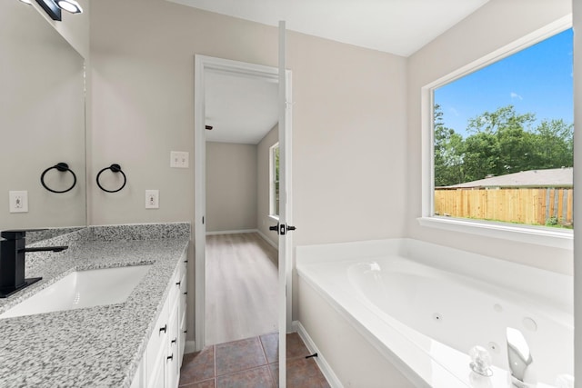 519 Tallow Dr, Conroe, TX 77385 - bathroom featuring vanity and a jetted tub