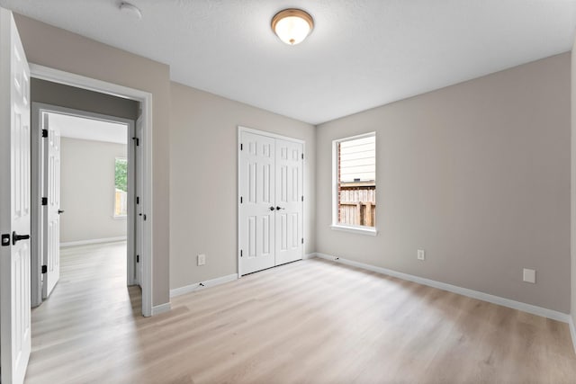519 Tallow Dr, Conroe, TX 77385 - unfurnished bedroom with light wood finished floors and a closet