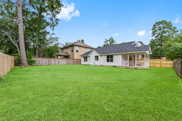 519 Tallow Dr, Conroe, TX 77385 - rear view of house with a porch, a fenced backyard, and a shingled roof