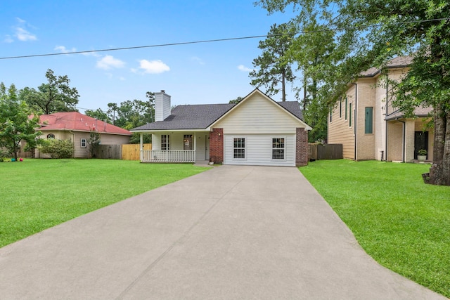 519 Tallow Dr, Conroe, TX 77385 - view of front of property featuring a porch, driveway, a chimney, brick siding, and a shingled roof