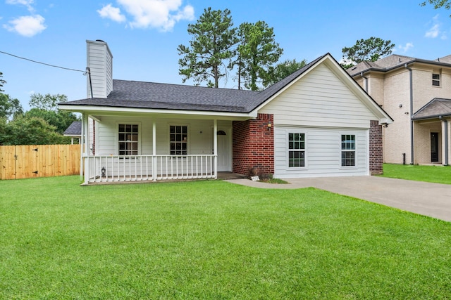 519 Tallow Dr, Conroe, TX 77385 - view of front of property featuring covered porch, a shingled roof, brick siding, and a chimney