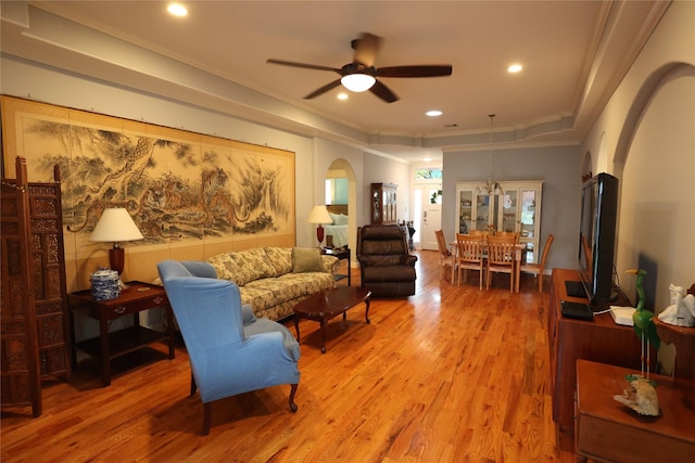 212 Greenwood St, Houston, TX 77011 - living room with arched walkways, a ceiling fan, light wood-type flooring, crown molding, and a raised ceiling