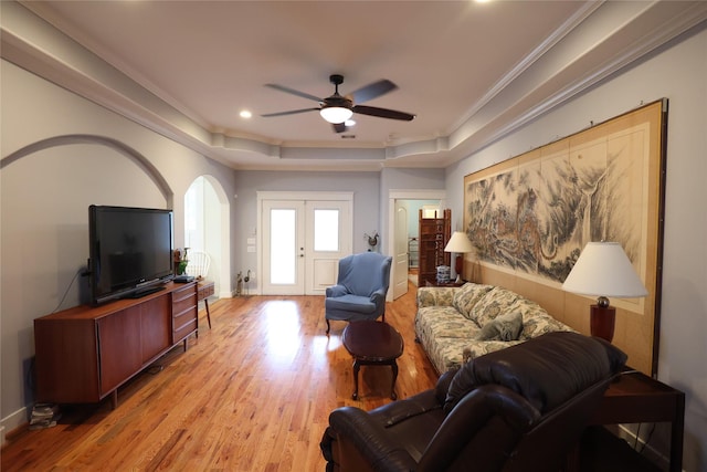 212 Greenwood St, Houston, TX 77011 - living room featuring light wood-style flooring, a ceiling fan, crown molding, a tray ceiling, and recessed lighting