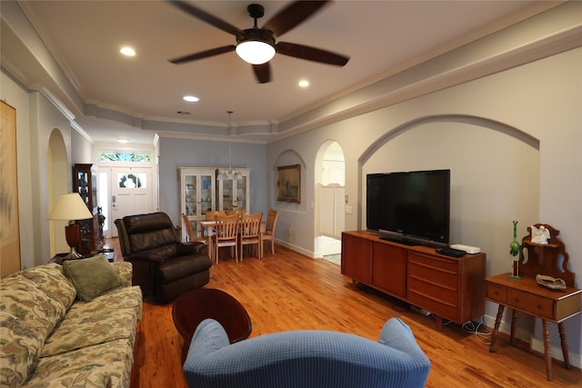 212 Greenwood St, Houston, TX 77011 - living room with arched walkways, ornamental molding, light wood-style floors, ceiling fan, and recessed lighting