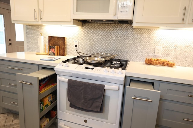 212 Greenwood St, Houston, TX 77011 - kitchen with white appliances, gray cabinets, decorative backsplash, and light countertops