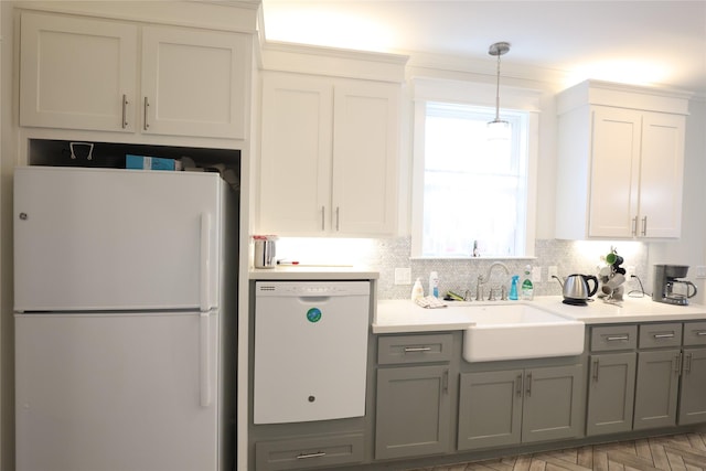 212 Greenwood St, Houston, TX 77011 - kitchen featuring white appliances, gray cabinets, hanging light fixtures, and light countertops