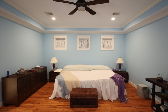 212 Greenwood St, Houston, TX 77011 - bedroom with wood finished floors, a tray ceiling, ceiling fan, and recessed lighting