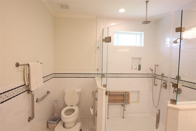 212 Greenwood St, Houston, TX 77011 - bathroom with a stall shower, a wainscoted wall, tile walls, and recessed lighting