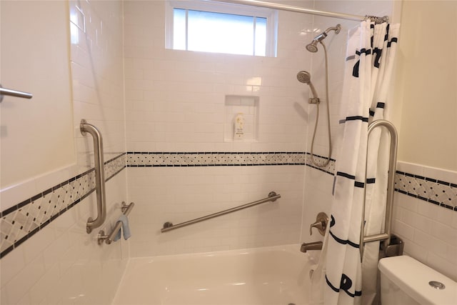 212 Greenwood St, Houston, TX 77011 - bathroom with shower / tub combo, tile walls, and wainscoting