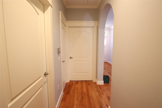 212 Greenwood St, Houston, TX 77011 - hallway with light wood finished floors, arched walkways, and ornamental molding