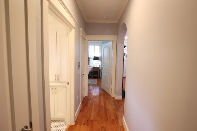 212 Greenwood St, Houston, TX 77011 - corridor with light wood-style flooring, ornamental molding, and arched walkways