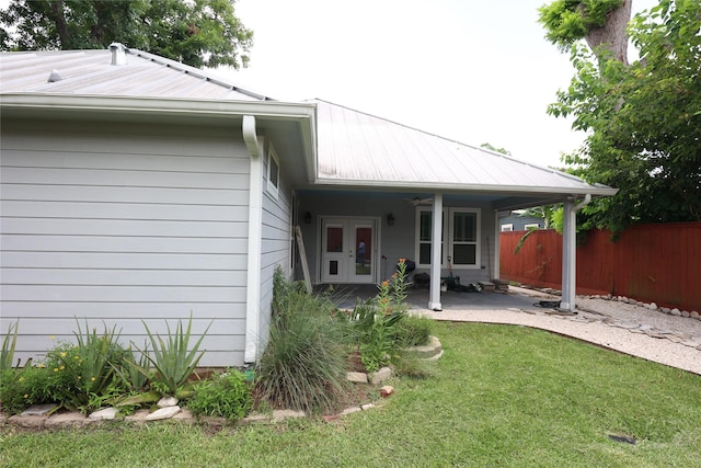 212 Greenwood St, Houston, TX 77011 - rear view of house featuring french doors, a patio area, and a metal roof