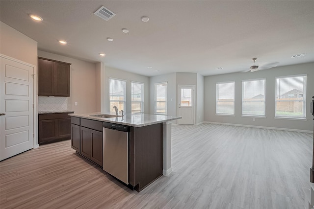 27302 Blue Pool Dr, Katy, TX 77493 - kitchen featuring dishwasher, light wood-type flooring, backsplash, dark brown cabinets, and open floor plan