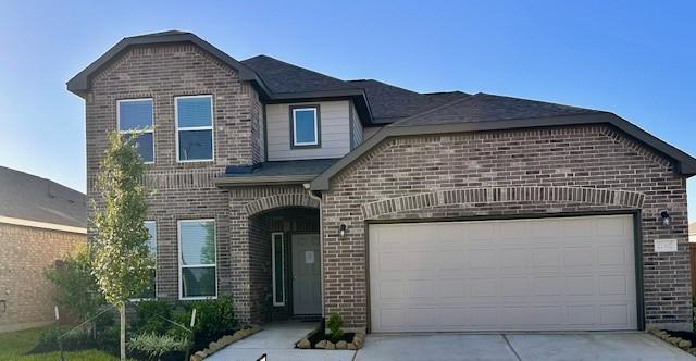27302 Blue Pool Dr, Katy, TX 77493 - view of front of house with brick siding, driveway, and an attached garage