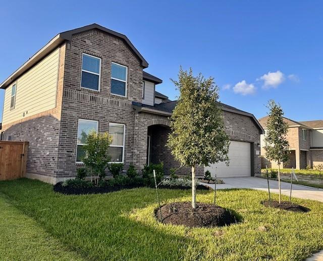 27302 Blue Pool Dr, Katy, TX 77493 - traditional-style home with brick siding, concrete driveway, an attached garage, and a front yard