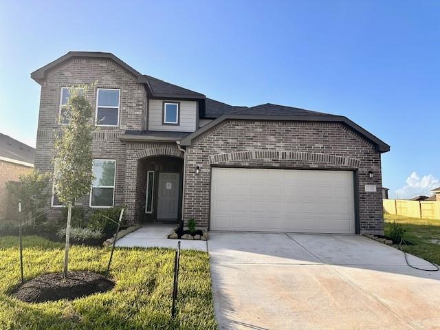 27302 Blue Pool Dr, Katy, TX 77493 - traditional home featuring brick siding, concrete driveway, an attached garage, and a front lawn