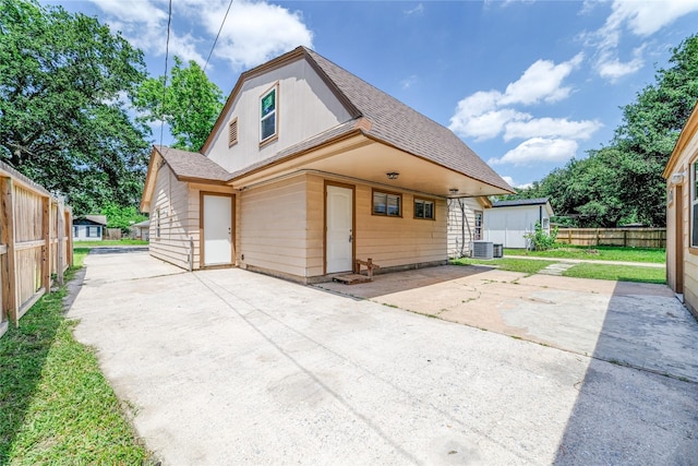 1309 Jefferson St, Baytown, TX 77520 - view of front of home featuring roof with shingles, concrete driveway, and a patio area