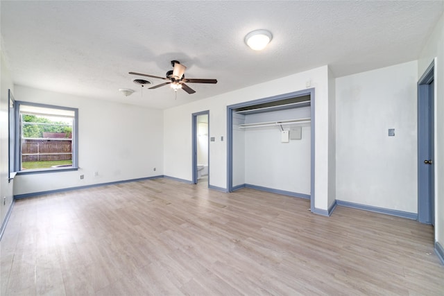 1309 Jefferson St, Baytown, TX 77520 - unfurnished bedroom featuring light wood-style flooring, a textured ceiling, and a closet