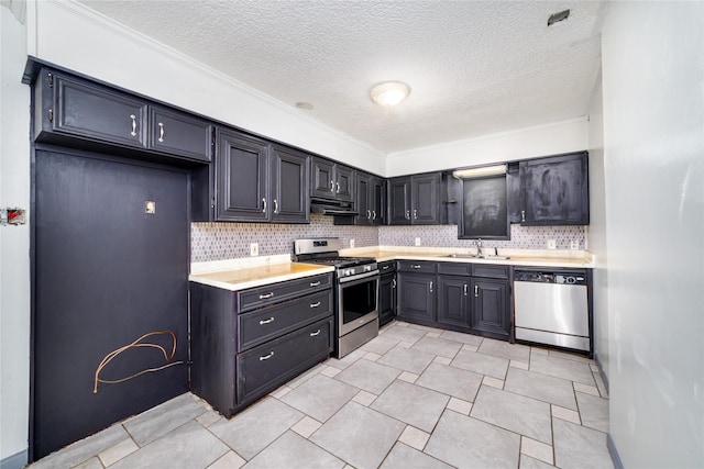 1309 Jefferson St, Baytown, TX 77520 - kitchen featuring appliances with stainless steel finishes, light countertops, exhaust hood, backsplash, and a textured ceiling