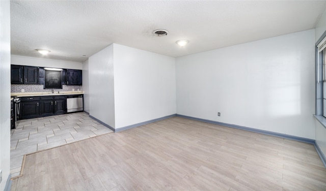 1309 Jefferson St, Baytown, TX 77520 - unfurnished living room featuring light wood finished floors and a textured ceiling