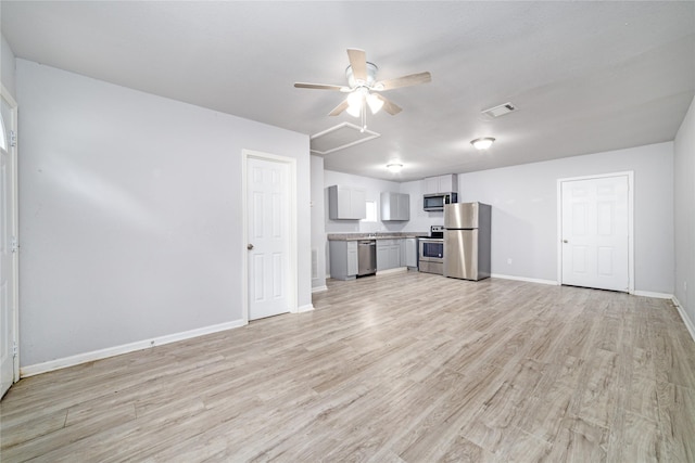 1309 Jefferson St, Baytown, TX 77520 - unfurnished living room with light wood-type flooring and ceiling fan
