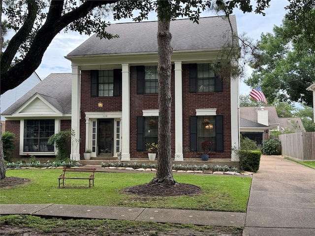 128 Hidden Lake Dr, League City, TX 77573 - greek revival inspired property featuring brick siding and roof with shingles