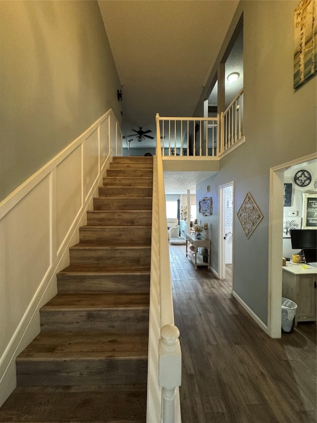 128 Hidden Lake Dr, League City, TX 77573 - stairs featuring ceiling fan, a high ceiling, and wood finished floors