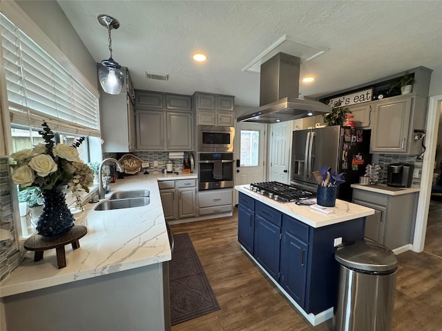 128 Hidden Lake Dr, League City, TX 77573 - kitchen featuring stainless steel appliances, island range hood, decorative backsplash, a kitchen island, and a textured ceiling