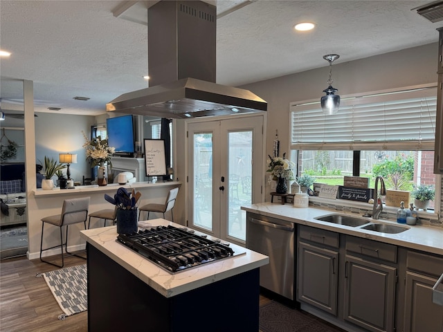 128 Hidden Lake Dr, League City, TX 77573 - kitchen with island exhaust hood, appliances with stainless steel finishes, a textured ceiling, gray cabinets, and plenty of natural light
