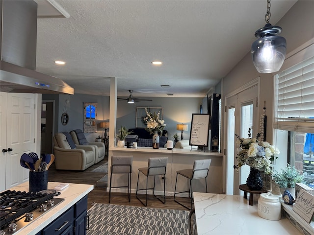 128 Hidden Lake Dr, League City, TX 77573 - kitchen with island range hood, open floor plan, blue cabinets, a ceiling fan, and light countertops
