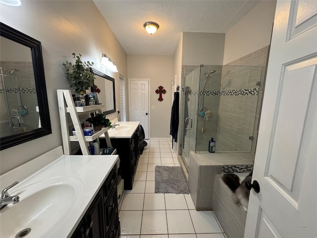 128 Hidden Lake Dr, League City, TX 77573 - full bath with a shower stall, tile patterned floors, a textured ceiling, and two vanities