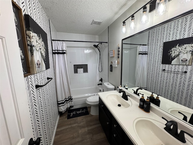 128 Hidden Lake Dr, League City, TX 77573 - bathroom with shower / tub combo, wood finished floors, double vanity, and a textured ceiling