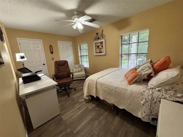 128 Hidden Lake Dr, League City, TX 77573 - bedroom featuring dark wood-style flooring, a textured ceiling, multiple windows, and ceiling fan