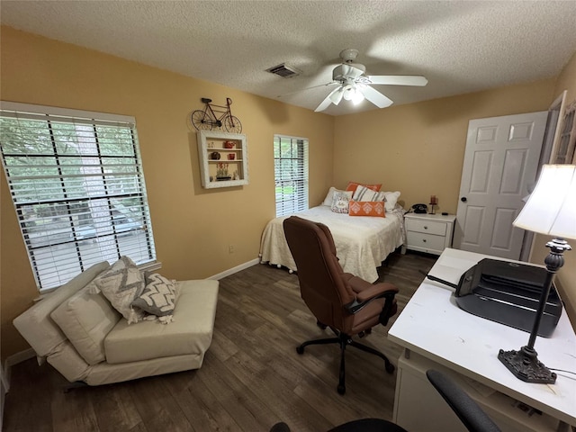 128 Hidden Lake Dr, League City, TX 77573 - bedroom featuring multiple windows, a textured ceiling, dark wood-style floors, and a ceiling fan