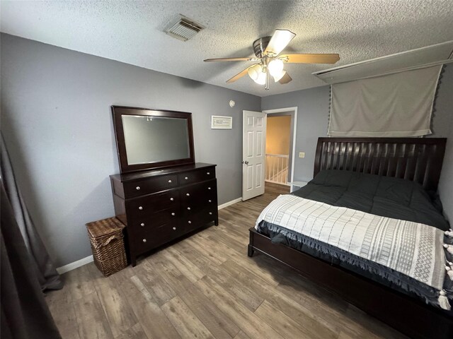 128 Hidden Lake Dr, League City, TX 77573 - bedroom with wood finished floors, a textured ceiling, and a ceiling fan